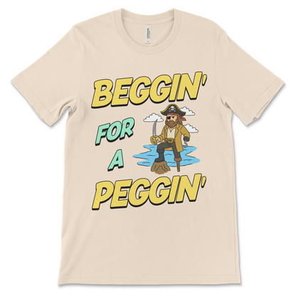 Tshirt with the phrase Beggin’ for a Peggin’, an offensive meme shirt with sexual innuendo, vulgar humor, and an unhinged pirate.
