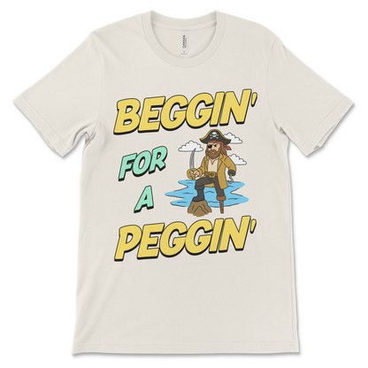 Tshirt with the phrase Beggin’ for a Peggin’, an offensive meme shirt with sexual innuendo, vulgar humor, and an unhinged pirate.