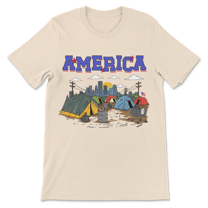 Funny America tent city shirt featuring a satirical homeless encampment beneath a patriotic America logo.