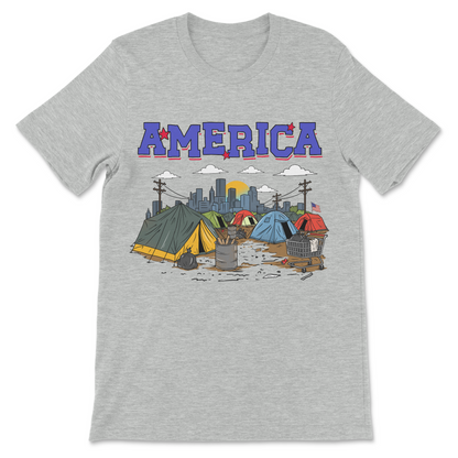 America shirt showing a homeless tent camp, shopping cart, and city skyline in ironic tourist style.
