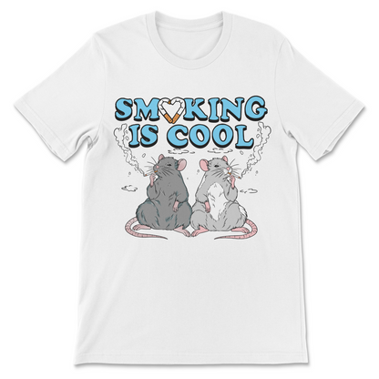 A white short-sleeve crewneck t-shirt featuring a graphic print of two cartoon rats smoking with clouds coming out of their mouths under the text 'SMOKING IS COOL' in light blue letters with a heart-shaped cigarette filter.
