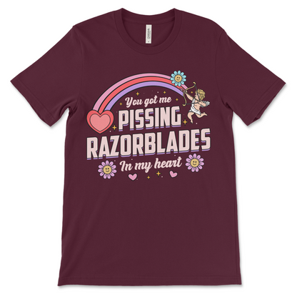 maroon t shirt with the phrase “Pissing Razorblades,” obnoxious and really offensive design, inappropriate dark humor shirt, weird funny couples gift and raunchy dirty adult humor shirt.