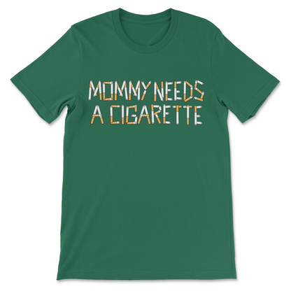 A green short-sleeve crewneck t-shirt with the text 'MOMMY NEEDS A CIGARETTE' printed across the chest in a stylized patterned font.