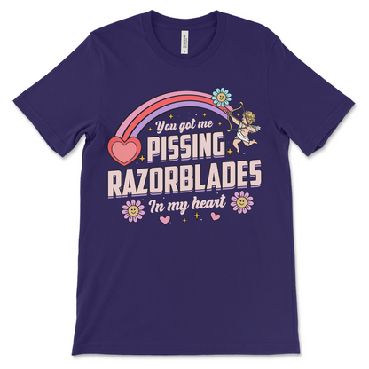 purple t shirt with the phrase “Pissing Razorblades,” obnoxious and really offensive design, inappropriate dark humor shirt, weird funny couples gift and raunchy dirty adult humor shirt.