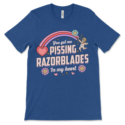 heather royal t shirt with the phrase “Pissing Razorblades,” obnoxious and really offensive design, inappropriate dark humor shirt, weird funny couples gift and raunchy dirty adult humor shirt.