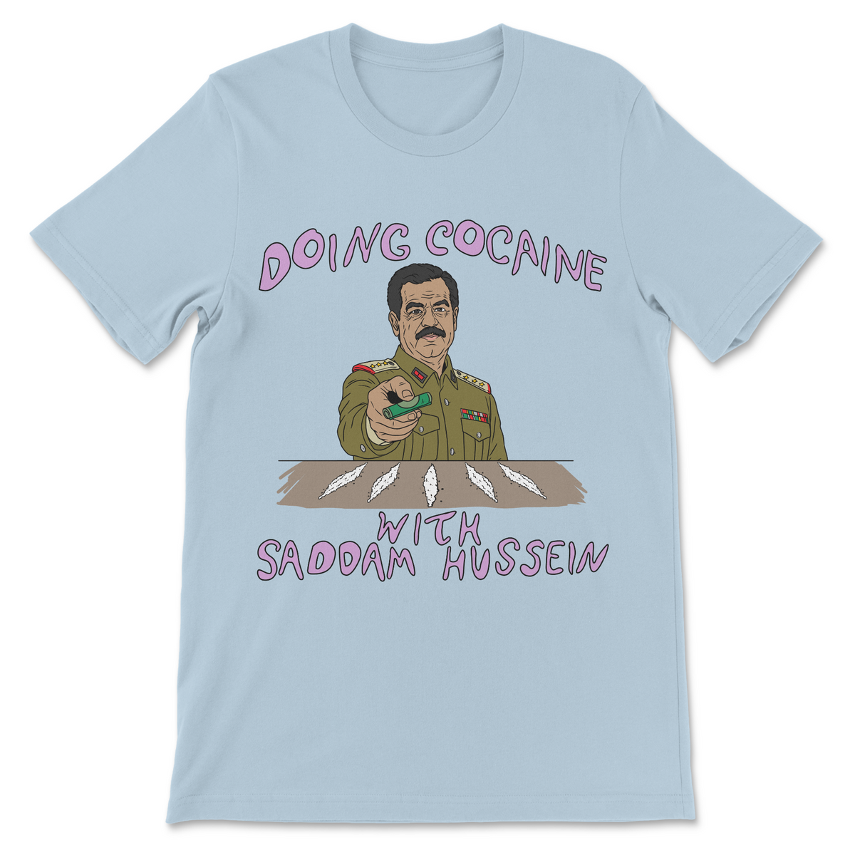 A light blue short-sleeve t-shirt with a cartoon graphic of Saddam Hussein holding a green drug, surrounded by white feathers, with the text 'DOING COCaine WITH SADDAM HUSSEIN' in pink lettering.