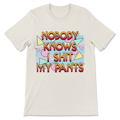 Retro graphic tee with the phrase "Nobody Knows I Shit My Pants" in an 80s and 90s inspired design.
